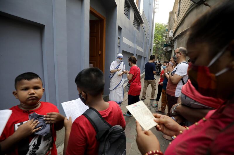 People pray at Mother Teresa's Mother House that is closed on Good Friday during the coronavirus COVID-19 pandemic in Kolkata, eastern India. Good Friday is a religious holiday observed by Christians in  commemoration of the crucifixion of Jesus Christ.  EPA