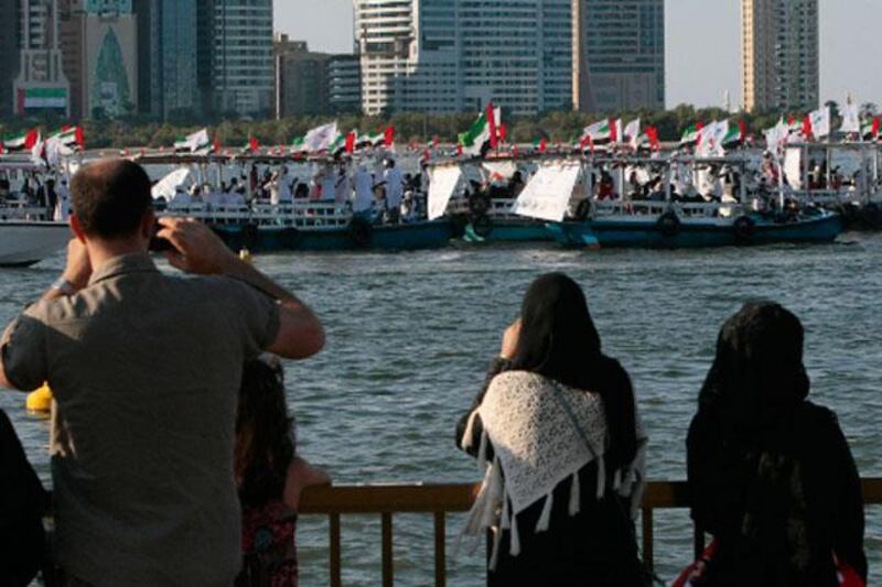 Sharjah, United Arab Emirates - December 2, 2012.  Boats passes by at the Al Khan lagoon in celebration of the 41st UAE National Day.  ( Jeffrey E Biteng / The National )