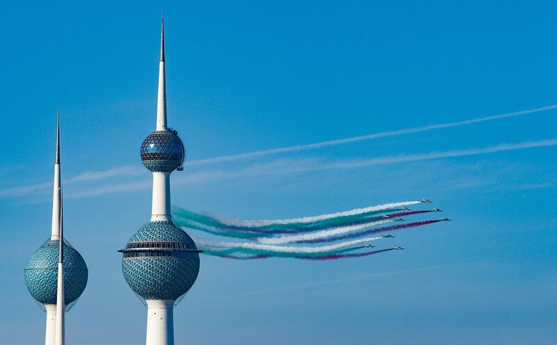 The Italian Air Force's acrobatic team Frecce Tricolori fly past the Kuwait Towers during a performance in Kuwait City. EPA