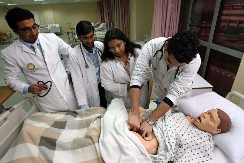 Suleman Shah, left, a clinical instructor at the Ras al Khaimah Medical and Health Sciences University, guides medical students Syed Mohammed, Rashi Sen and Mahmood Mohammed Abdulbadie, through an abdominal examination of Annie, a female mannequin.