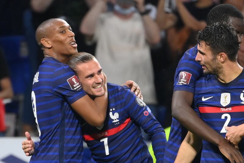 France forward Antoine Griezmann is congratulated by Anthony Martial after scoring his team's second goal against Finland. AFP
