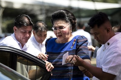 Former Philippine first lady Imelda Marcos is assisted to her car after visiting the tomb of former Philippine president and late dictator Ferdinand Marcos on National Heroes' Day at the Heroes Cemetery in Manila on August 28, 2017. AFP