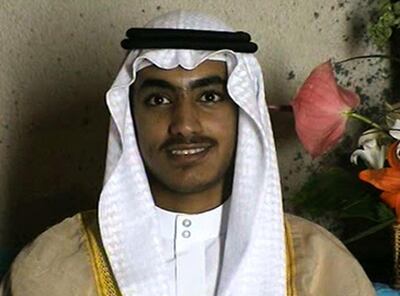 In this image from video released by the CIA, Hamza bin Laden is seen as an adult at his wedding. The never-before-seen video of Osama bin Laden's son and potential successor was released Nov. 1, 2017, by the CIA in a trove of material recovered during the May 2011 raid that killed the al-Qaida leader at his compound in Pakistan. The one hourlong video shows Hamza bin Laden, sporting a trimmed mustache but no beard, at his wedding. He is sitting on a carpet with other men. (CIA via AP)