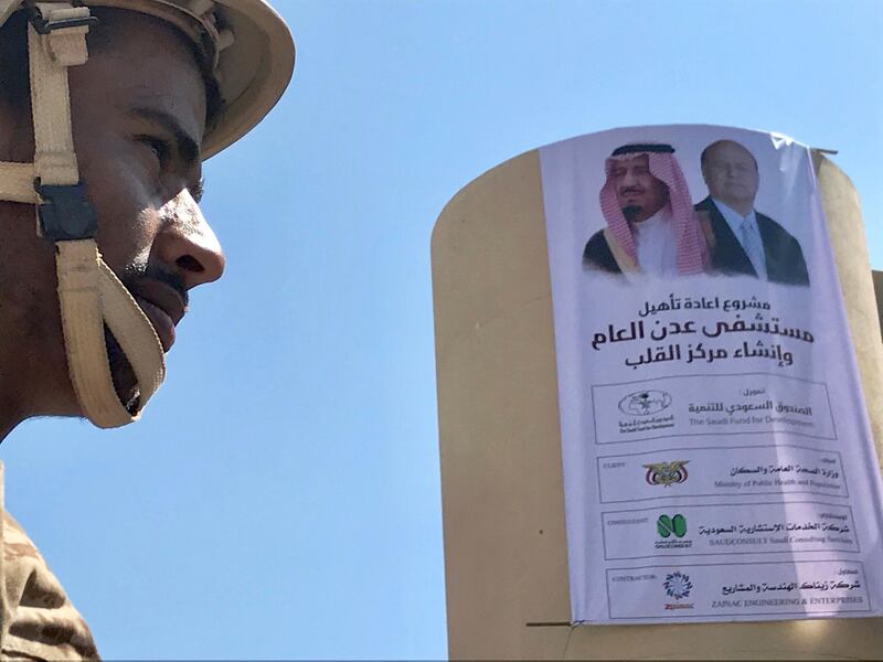 A soldier is pictured near a poster portraying Saudi Arabia's King Salman bin Abdulaziz Al Saud and Yemen's President Abdrabbuh Mansur Hadi in Aden, Yemen. Reuters