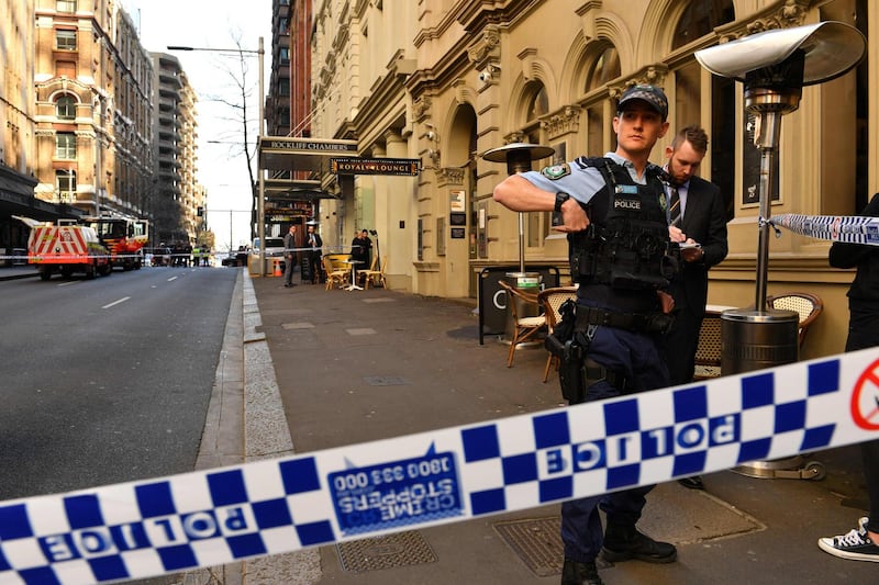 Police gather at the crime scene after a man stabbed a woman and attempted to stab others in central Sydney.  AFP