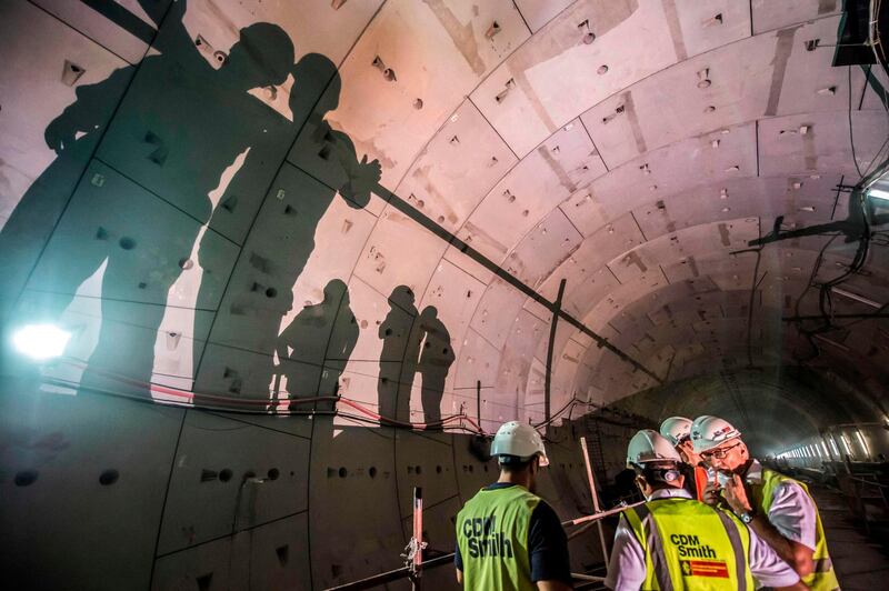 Site engineers on location in a new twin-tube road tunnel under construction to straddle the Suez Canal in the city of Ismailia, about 127 kms east of the capital Cairo. AFP