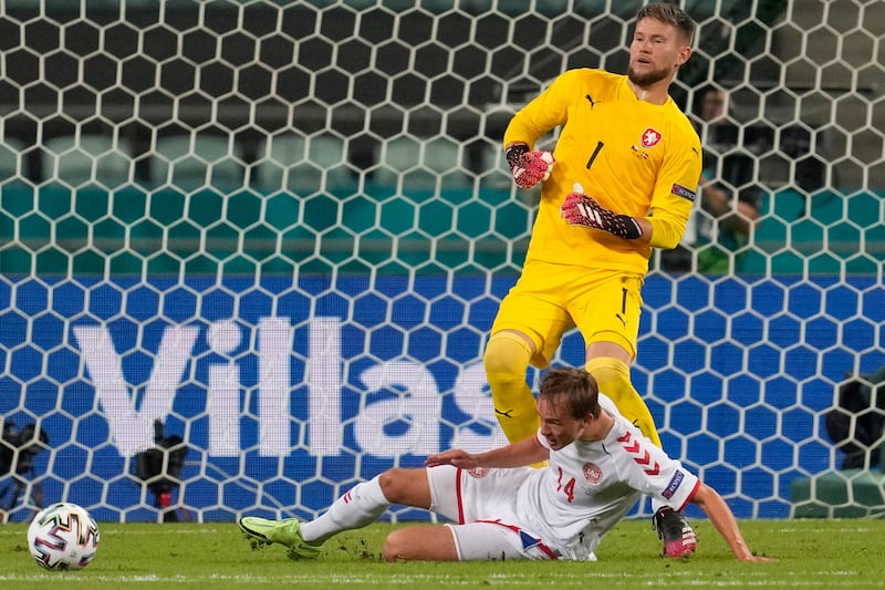 Czech Republic's goalkeeper Tomas Vaclik fights for the ball with Denmark's forward Mikkel Damsgaard.