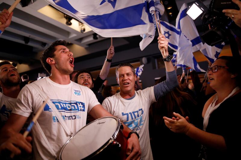 Supporters of Benny Gantz's Blue and White party react to exit polls in Israel's parliamentary election at the party headquarters in Tel Aviv, Israel April 9, 2019. REUTERS/Corinna Kern