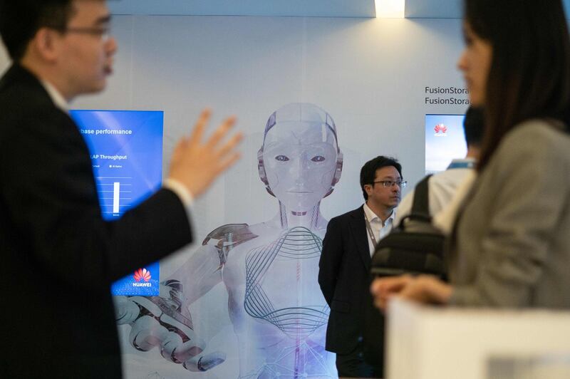 Journalists and guests attend the Huawei database and storage product launch during a press conference at the Huawei Beijing Executive Briefing Centre in  Beijing.  AFP