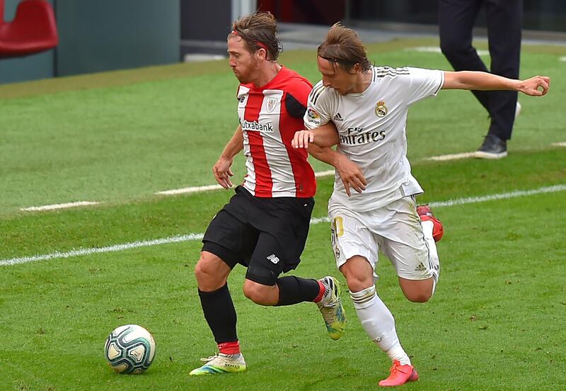 Real Madrid midfielder Luka Modric challenges Athletic Bilbao forward Iker Muniain. AFP