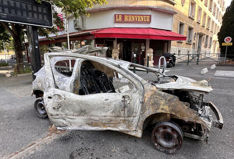 A burnt-out car a day after Nahel was killed by a French police officer during a traffic stop in Nanterre. Reuters