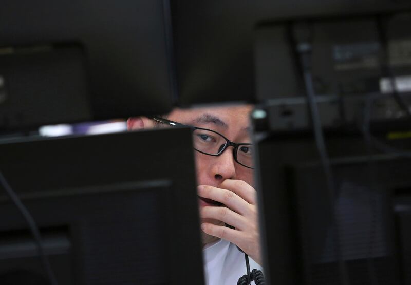 A currency trader in Seoul, South Korea. Ahn Young-joon / AP Photo