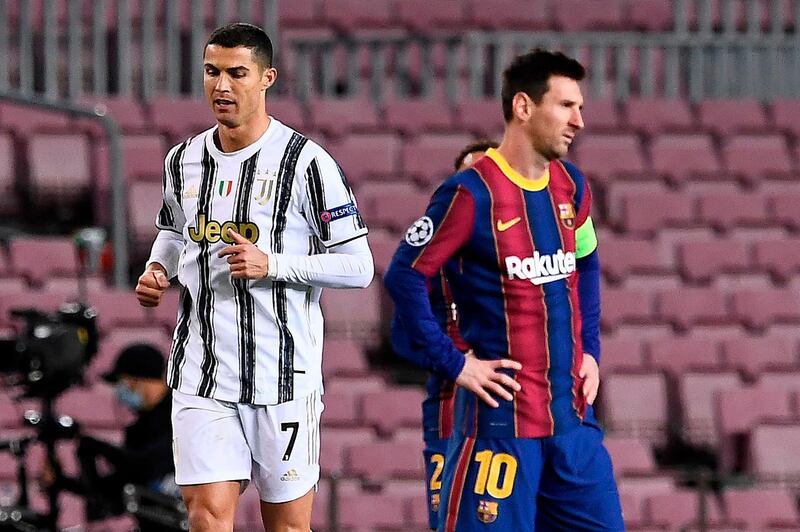 Juventus' Portuguese forward Cristiano Ronaldo (L) walks past Barcelona's Argentinian forward Lionel Messi during the UEFA Champions League group G football match between Barcelona and Juventus at the Camp Nou stadium in Barcelona on December 8, 2020. / AFP / Josep LAGO
