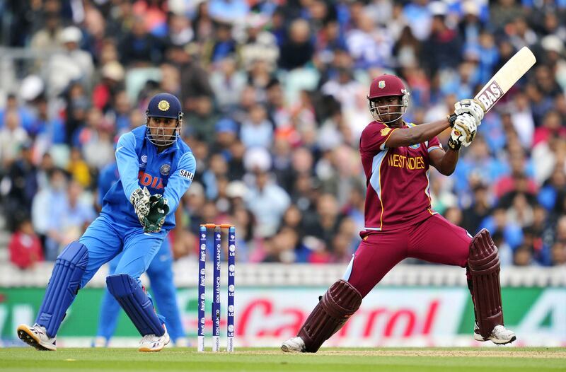 West Indies' Johnson Charles (R) steers the ball past India's Mahendra Dhoni during the 2013 ICC Champions Trophy cricket match between India and West Indies at The Oval in London on June 11, 2013. AFP PHOTO/GLYN KIRK  == RESTRICTED TO EDITORIAL USE  ==
 *** Local Caption ***  316265-01-08.jpg