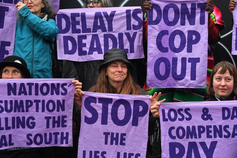 Members of climate action protest group Scientist Rebellion hold signs during a demonstration in Glasgow on the sidelines of the Cop26 summit. AFP