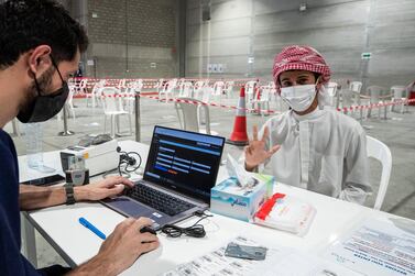 Abu Dhabi, United Arab Emirates, March 18, 2021. Mohammed Almansoori registers before getting his PCR test at the Biogenix lab at G42 in Masdar City. Victor Besa/The National Section: NA Reporter: Shireena Al Nowais