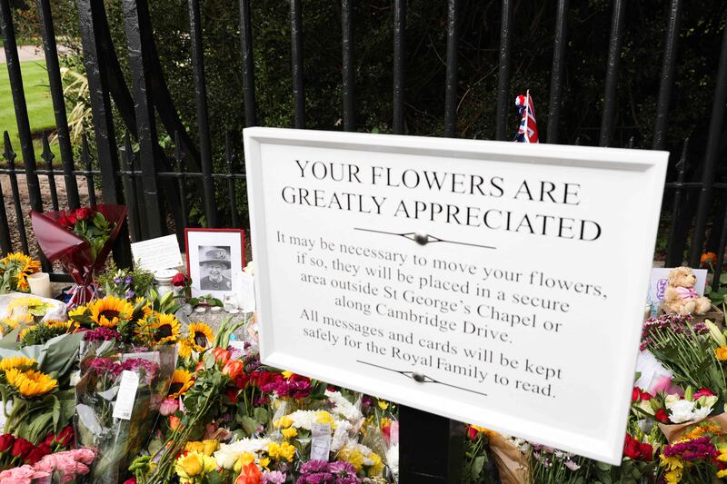 Flowers and tributes placed by mourners at the Cambridge gate outside Windsor Castle, west of London. AFP