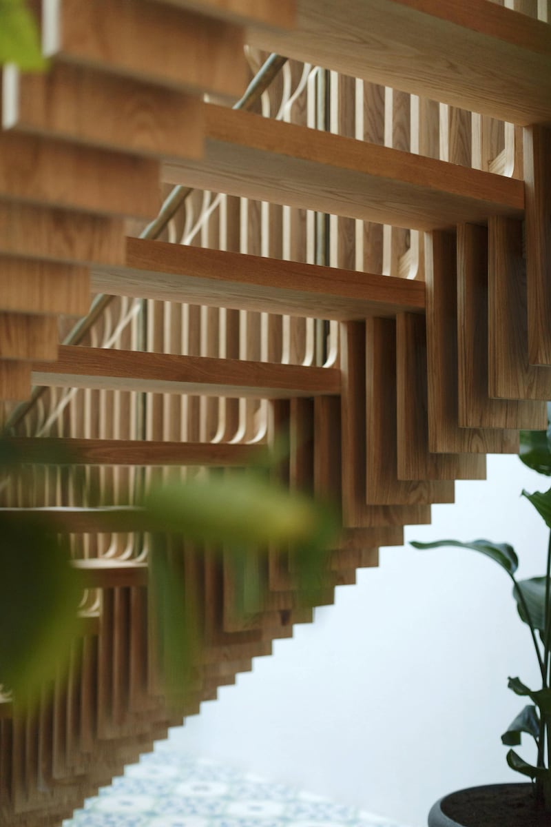 A central parametric staircase incorporates 700 hand-carved pieces of natural oak wood. Courtesy Ammar Basheir