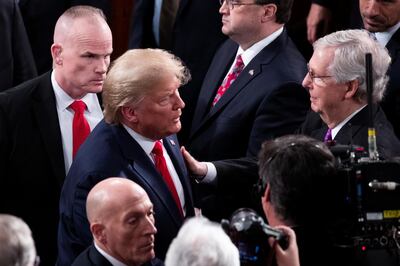 epa08193836 US President Donald J. Trump (C, left) greets Senate Majority Leader Mitch McConnell (R) after delivering his State of the Union address in the US House of Representatives on Capitol Hill in Washington, DC, USA, 04 February 2020. President Trump delivers his address as his impeachment trial is coming to an end with a final vote on the two articles of impeachment scheduled for 05 February.  EPA/MICHAEL REYNOLDS