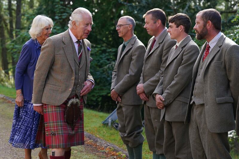 King Charles III and Queen Consort Camilla meet estate staff as they leave Crathie Parish Church, near Balmoral. PA