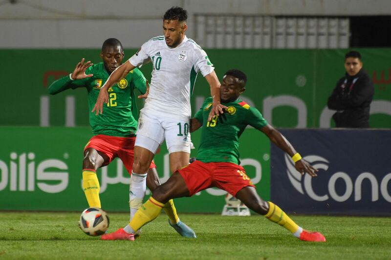 Algeria's Sofiane Feghouli is challenged by Karl Toko Ekambi and Collins Fai of Cameroon. AFP