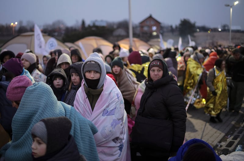 People who fled Ukraine wait for transport after crossing the border into Poland. AP