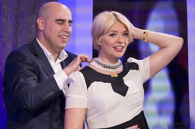 Vashi Dominguez putting a diamond necklace on Holly Willloughby, the presenter of UK television show This Morning. Photo: Shutterstock