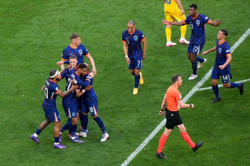 Donyell Malen of the Netherlands celebrates with teammates after scoring his side's second goal. AP