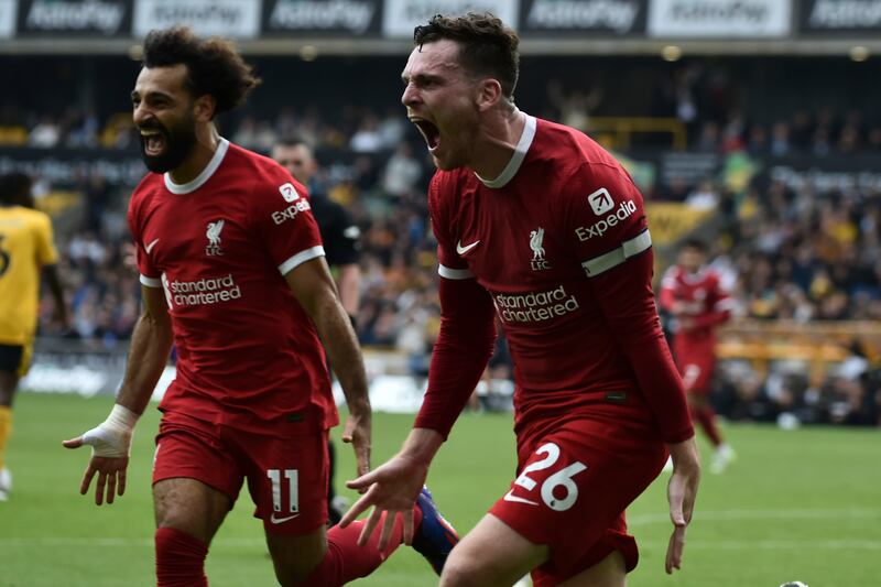Andrew Robertson, right, celebrates with Mohamed Salah after scoring Liverpool's second goal in their 3-1 Premier League win over Wolves at Molineux on September 16, 2023. AP