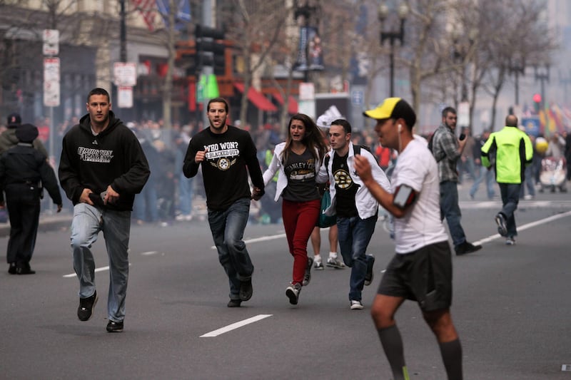 In this photo provided by The Daily Free Press and Kenshin Okubo, people react to an explosion at the 2013 Boston Marathon in Boston, Monday, April 15, 2013. Two explosions shattered the euphoria of the Boston Marathon finish line on Monday, sending authorities out on the course to carry off the injured while the stragglers were rerouted away from the smoking site of the blasts. (AP Photo/The Daily Free Press, Kenshin Okubo) MANDATORY CREDIT *** Local Caption ***  Boston Marathon Explosions.JPEG-0e210.jpg