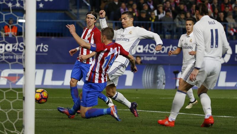 Real Madrid’s Cristiano Ronaldo in action with Atletico Madrid’s Gabi. Javier Barbancho / Reuters