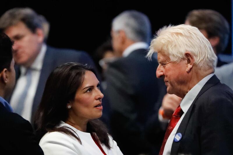 Conservative MP Priti Patel (L) talks with Stanley Johnson (R), father of Conservative MP Boris Johnson, at an event to announce the winner of the Conservative Party leadership contest in central London on July 23, 2019. / AFP / Tolga AKMEN
