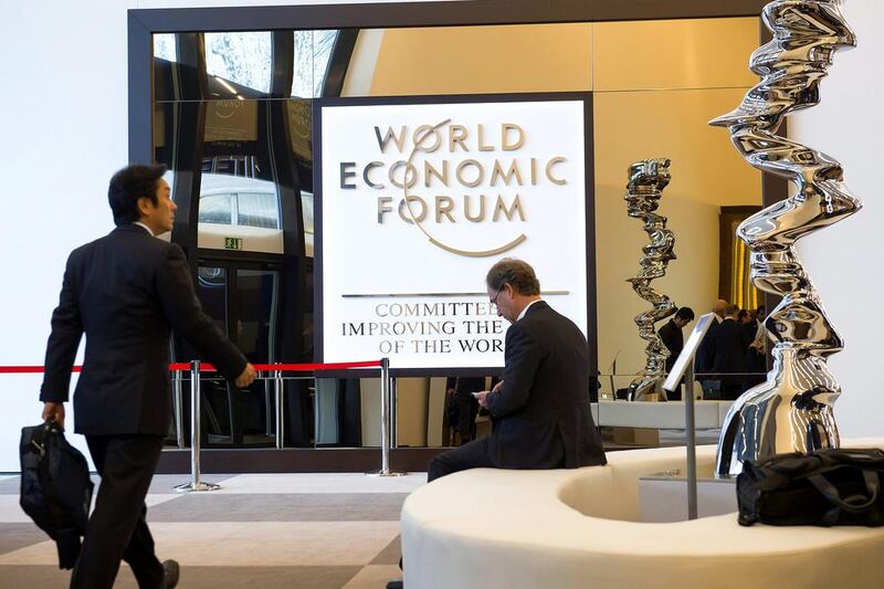 People gather inside the Congress centre during the first day of the 45th Annual Meeting of the World Economic Forum (WEF), in Davos. Jean-Christophe Bott / EPA