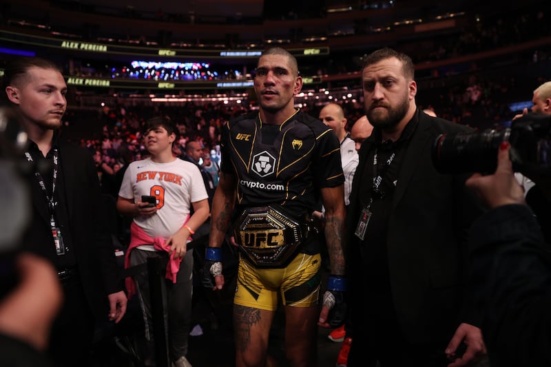 Alex Pereira walks out of the octagon with the middleweight title after defeating Israel Adesanya. Getty