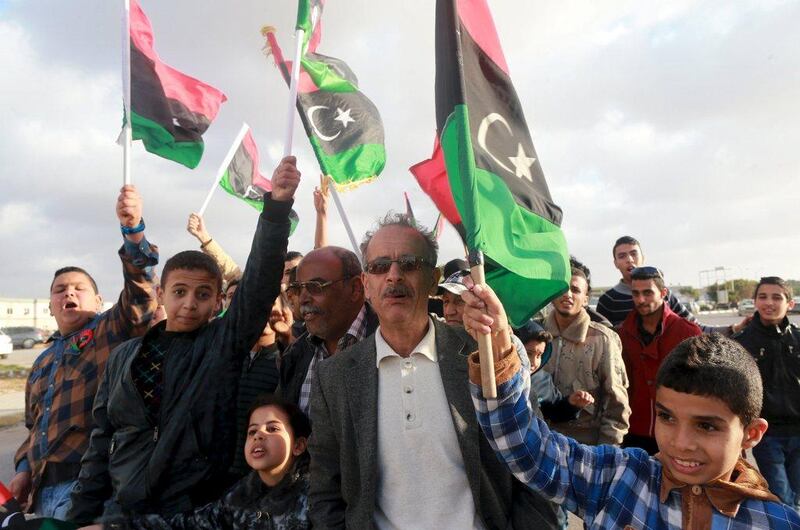 Libyans wave their national flags as they celebrate  the internationally-recognised government's gains in Benghazi on February 24, 2016. Esam Omran Al Fetori /Reuters

