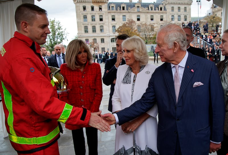 King Charles meets firefighters at Notre-Dame, which was devastated by a blaze in April 2019. AP