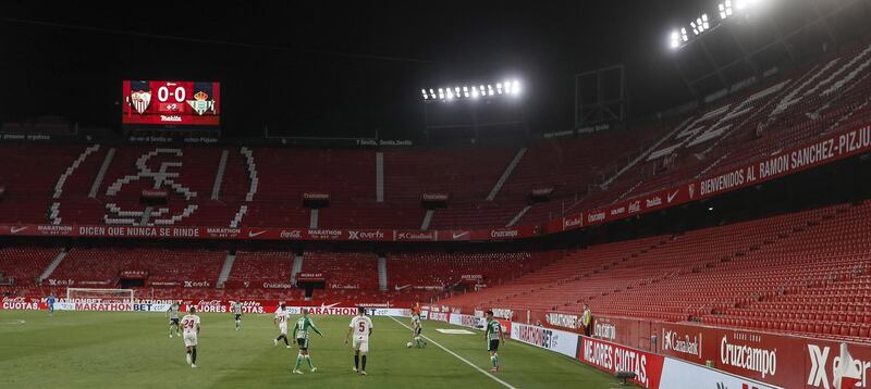 Sevilla and Real Betis' players in action in front of empty stands at the  Ramon Sanchez Pizjuan Stadium. EPA