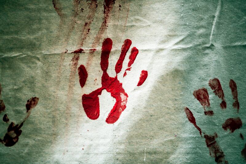 A protester leaves a red hand print on canvas as hundreds  gather to observe the anniversary of mass atrocities by the Ottomans against Armenians, considered by many to amount to genocide. EPA