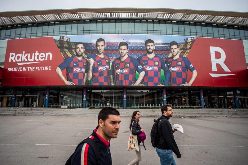 Pedestrians pass Barcelona's Camp Nou stadium. Bloomberg
