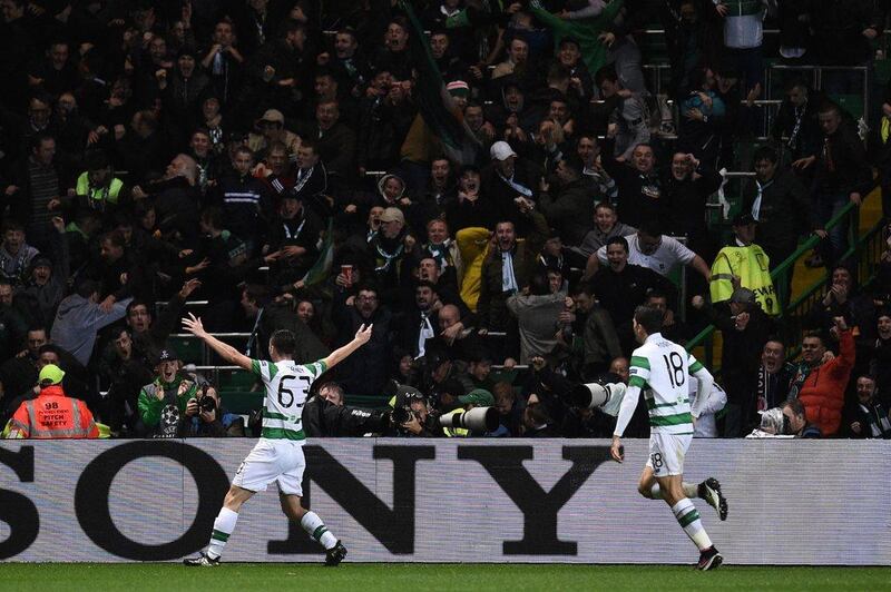 Celtic’s Kieran Tierney, left, celebrates scoring his team’s second goal from a deflection by Manchester City’s Raheem Sterling (unseen). Oli Scarff / AFP