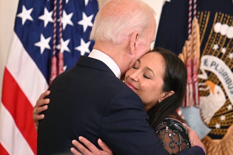 Mr Biden embraces Danielle Robinson, the widow of Sgt First Class Heath Robinson. AFP