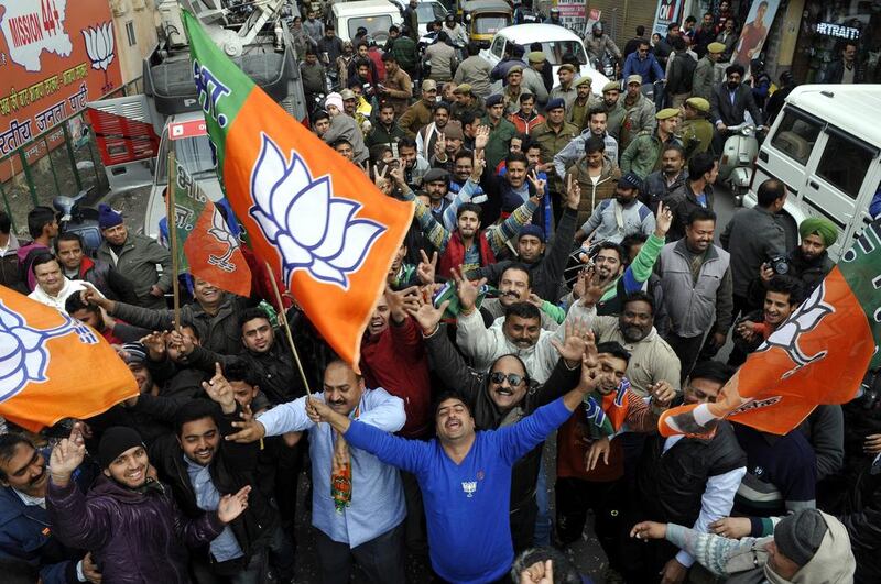 Supporters of the Bharatiya Janata Party celebrate in Jammu, the winter capital of Kashmir, as results of the state assembly election were announced on December 23, 2014. Jaipal Singh / EPA