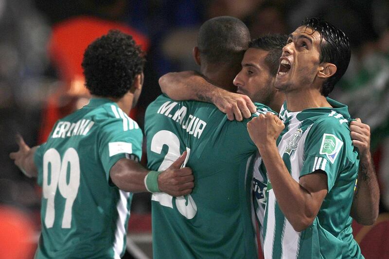Raja Casablanca's Mouhssine Iajour, second from left, celebrates his goal against Atletico Mineiro with his teammates during their Fifa Club World Cup semi-final on Wednesday. The Moroccan club faces Bayern Munich in the final on Saturday. Amr Abdallah Dalsh / Reuters