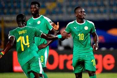 Senegal's midfielder Henri Saivet (L) shakes hands with Senegal's forward Sadio Mane (R) during the 2019 Africa Cup of Nations (CAN) Group C football match between Kenya and Senegal at the 30 June Stadium in the Egyptian capital Cairo on July 1, 2019. / AFP / Khaled DESOUKI