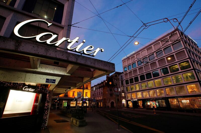 FILE PHOTO: A Cartier logo, part of Richemont luxury group, is pictured on a shop window next to the Louis Vuitton store in Geneva, Switzerland, November 23, 2017. REUTERS/Denis Balibouse/File Photo