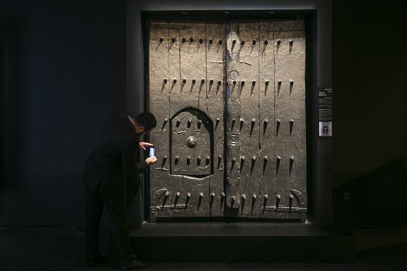 The original wooden gate to Qasr Al Hosn is among the treasured items captured from the past and put on display at an exhibition that opened to the public on Wednesday. Mona Al Marzooqi / The National