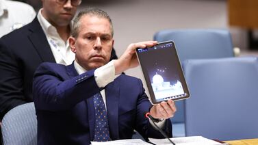 Israeli Ambassador to the UN Gilad Erdan shows a video of drones and missiles heading toward Israel during a United Nations Security Council meeting on the situation in the Middle East, including Iran's recent attack against Israel, at UN headquarters in New York City on April 14, 2024.  Erdan urged the Security Council to impose "all possible sanctions" against Iran after the Islamic republic's unprecedented attack against Israel.  (Photo by Charly TRIBALLEAU  /  AFP)