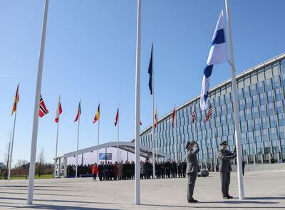 Finnish military personnel hoist the national flag at the Nato headquarters in Brussels. AFP