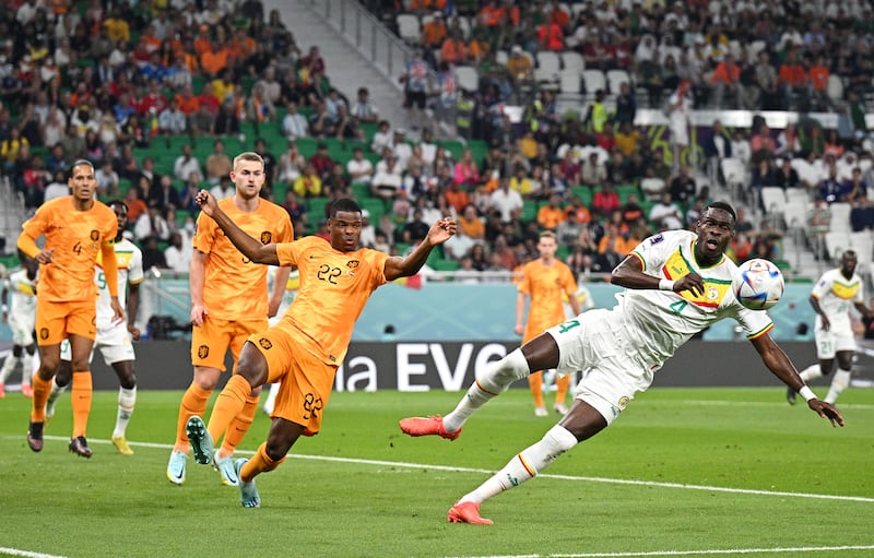 Denzel Dumfries of the Netherlands battles for possession with Pape Abou Cisse of Senegal. Getty