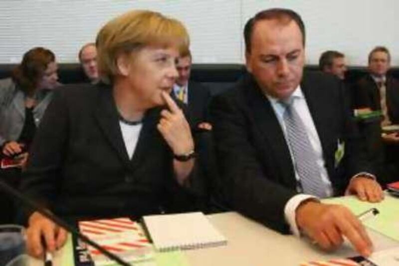 BERLIN - SEPTEMBER 30:  German Chancellor Angela Merkel and Axel Weber, head of the German central bank, the Bundesbank, sit down for a meeting of the German Christian Democrats (CDU) faction of the Bundestag on September 30, 2008 in Berlin, Germany. Weber is meeting with Germany's political parties to discuss the ongoing world financial crisis.  (Photo by Sean Gallup/Getty Images) *** Local Caption ***  GYI0055853341.jpg